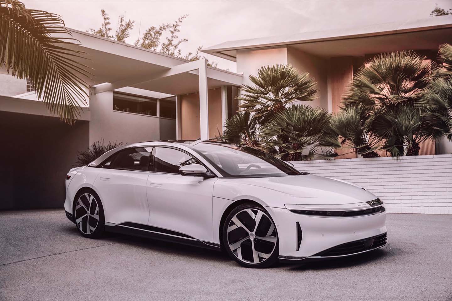 lucid air white parked in driveway