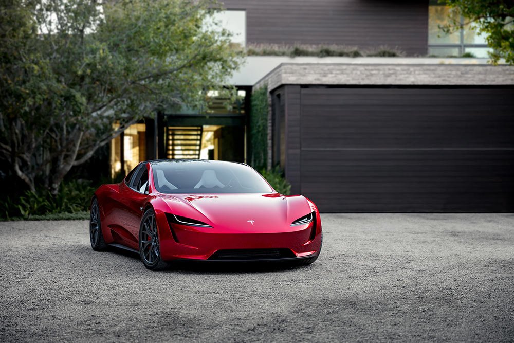 Tesla Roadster Parked in Front of House